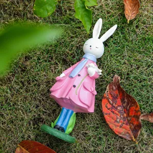 Creative resin rabbit figurine holding a flower, perfect desktop and home decoration gift.
