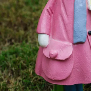 Close-up detail shot of cute pink resin rabbit figurine featuring lovely coat design.