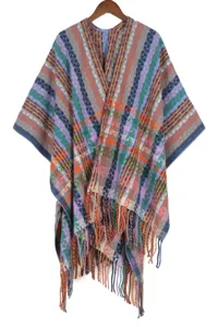 Bohemian colorful knitted poncho detail, close-up of geometric pattern and warm fringe hem.