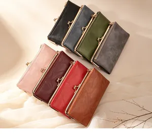 Vintage long wallet for women with kiss-lock clasp and card slots, stylish clutch bag.