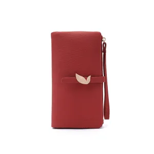 Red PU leather long wallet detail, golden leaf metal buckle, wrist strap close-up view.