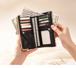Black leather long wallet with kiss lock closure, multiple card slots and zipper coin pocket.