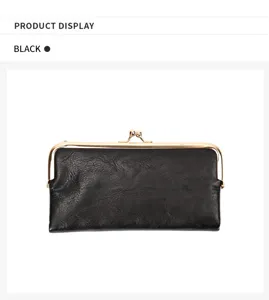 Black long wallet with vintage gold kiss-lock metal frame and sleek minimalist design detail.