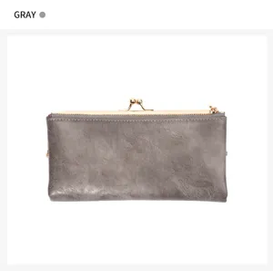 Close-up of grey vintage kiss-lock long wallet showing fine texture and metal clasp closure.