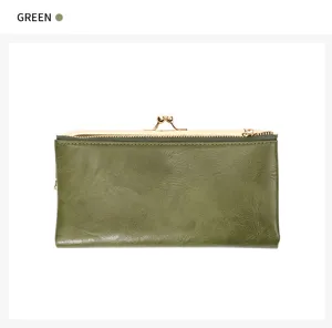 Close-up detail of the vintage green long wallet featuring kiss-lock and zipper pocket design.