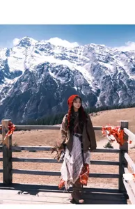 Outdoor scenic detail view of a stylish red knitted tassel beanie hat for women travel.