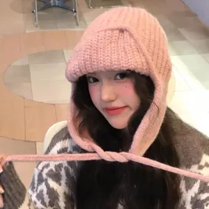 Pink knit earflap hat for women, cute winter fluffy wool pilot beanie for sweet daily style.