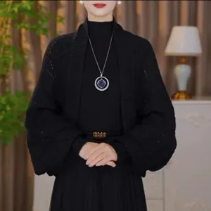 Black knit cardigan detail, hollow out warm shawl design, elegant autumn winter apparel.