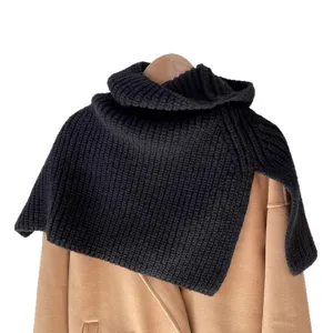 Detailed shot of dark grey knit split turtleneck cape, showing thick texture and cozy design.