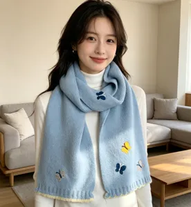 Charming blue knit scarf featuring delicate butterfly embroidery and cozy winter warmth design.
