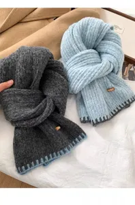 Thick knitted winter scarf set with ribbed texture, cozy warmth, stylish color block hem design.