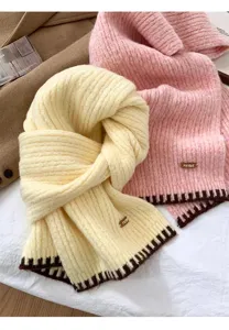 Cozy knitted winter scarf detail, soft wool texture, warm neck wrap with stylish contrast edge.