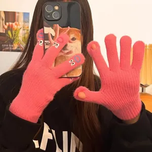 Cute winter knitted gloves for women, warm five-finger touchscreen pink funny monster design.