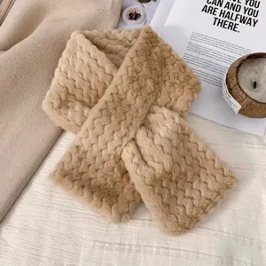 Details of the thick plush cross scarf, showing soft fluffy texture and warm winter design.