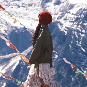 Red knit beanie hat with tassels for women winter outdoor travel and cold weather fashion style.