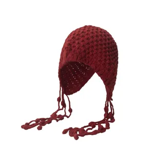 Red knitted crochet beanie hat with long tassels and ear flaps for women autumn winter.