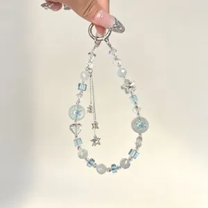 Detailed view of ins-style crystal beaded phone charm with double layer star tassel.