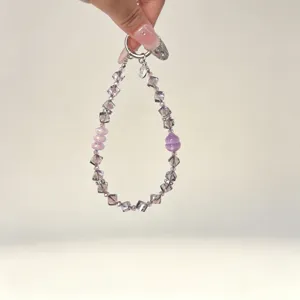 Crystal beaded phone charm and bag pendant, niche design luxury accessory for women.