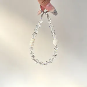 Crystal beaded phone charm detail, clear faceted beads and gourd pendant for bag decor.