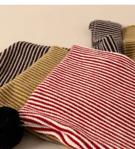 Children striped knit scarf hat detail close-up soft cozy winter warm woolen wear kids.