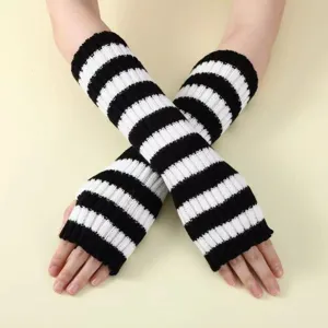 Detail shot of black and white striped knitted arm warmers, cozy wool half finger winter gloves.