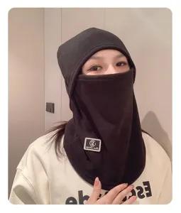 Close-up of the black fleece thermal balaclava showing soft fabric and woven patch.