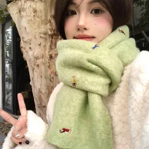 Detailed shot of cute dachshund embroidered knitted scarf in light green for daily winter wear.
