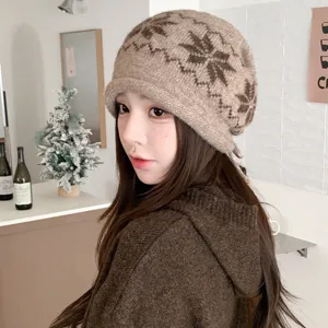 Brown knit beanie detail, cozy winter woolen hat with snowflake jacquard pattern and brim.
