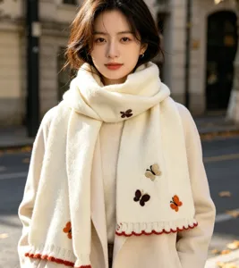 Detailed view of the winter knitted scarf featuring cute embroidered butterfly patterns.