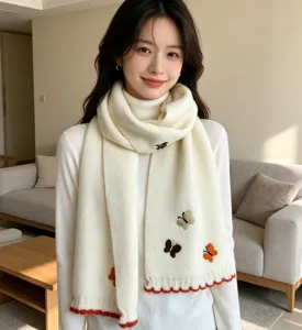Cozy knit winter scarf for women featuring cute butterfly embroidery and stylish red edge.