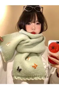 Cute green knitted winter scarf detail featuring colorful embroidered butterfly patterns.