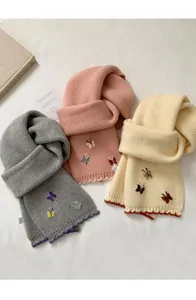 Cozy knitted winter scarf featuring cute embroidered butterflies and stylish contrast scalloped edges.