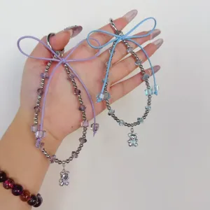 Crystal beaded phone charm with cute bear pendant and ribbon bow, short wrist strap.