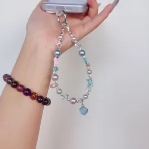 Crystal pearl phone charm detail, handmade beaded wrist strap for phone case and bag.