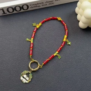 Cute Chinese style panda pendant phone charm, red bamboo beaded bag accessory detail view.