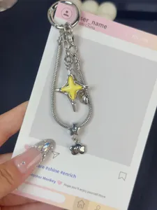 Exquisite detail of Y2K star snake chain keychain with yellow enamel pendant for chic bags.