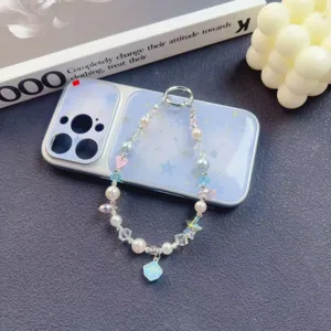 Exquisite beaded phone chain detail, featuring pearls, crystals and a cute starry phone case.