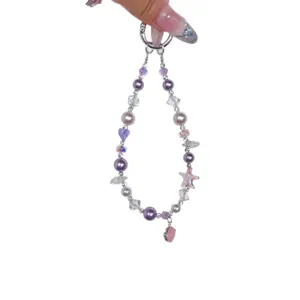 Handmade beaded phone charm with purple pearls, crystal beads and cute starfish pendant accessory.
