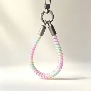 Close-up detail of colorful telephone wire TPU wrist phone strap with silver metal clasp.