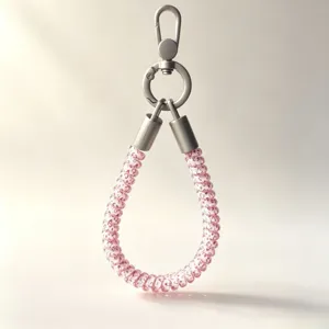 Close-up detail of the pink telephone cord phone strap with silver metal clasp and connectors.