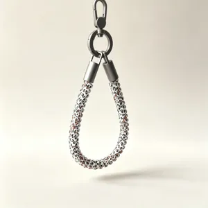 Close-up detail of the leopard print beaded phone lanyard with metallic hardware and clasp.