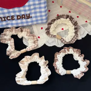 Brown plaid and polka dot hair scrunchies detail view, cute ruffled lace hair tie accessory.
