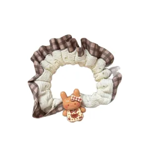 Cute brown plaid hair scrunchie with cute bear charm and lace ruffle for sweet girls ponytail.