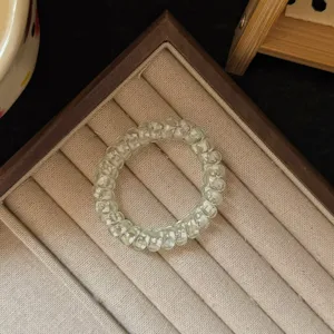 Clear transparent green telephone wire hair tie detail, elastic spiral hair band accessory.