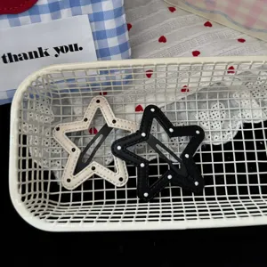 Chic black and white polka dot star hair clips detail, minimalist Korean style hair accessories.