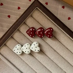Polka dot heart triple hair clip detail, showcasing red and white cute duckbill accessories.