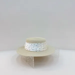 French style flat top straw hat detailed with elegant white polka dot scarf trim.