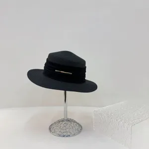 Black straw hat detail shot, elegant flat top fedora, summer sun protection beach hat