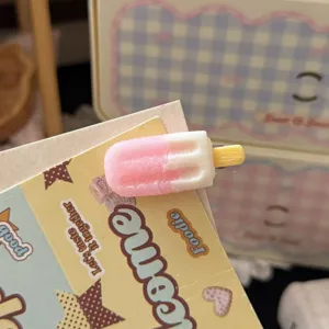 Close up detail shot of cute pink and white ice cream popsicle hair clip accessory on display card.