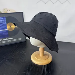 Detailed view of a black wide brim sun hat, Japanese style linen sunshade fisherman hat.